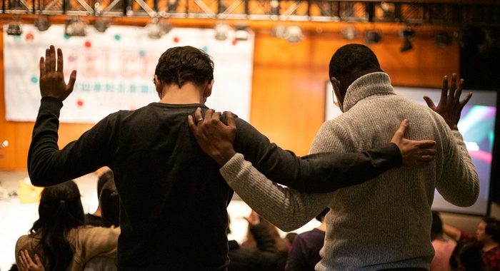 Two men praying for each other