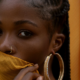 Photo by Adegboye Habeeb: https://www.pexels.com/photo/close-up-photo-of-a-woman-covering-her-mouth-with-a-yellow-fabric-9238599/