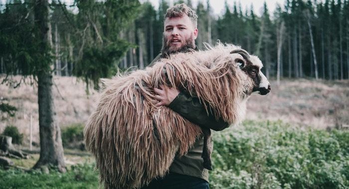 Man holding heavy sheep